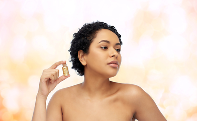 Image showing african american woman with gold mask in bottle