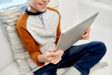 Image showing close up of boy with tablet pc computer at home