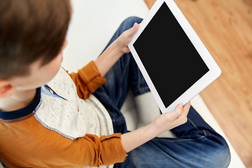 Image showing close up of boy with tablet pc computer at home