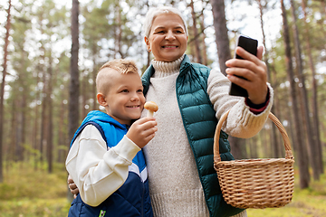 Image showing grandmother and grandson with baskets take selfie