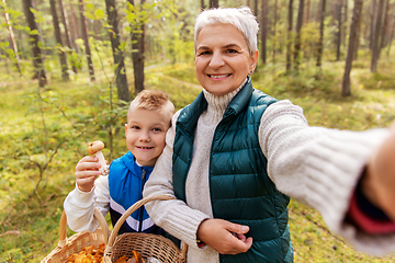 Image showing grandmother with grandson taking selfie in forest