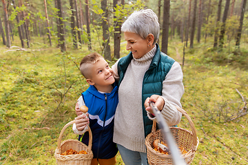 Image showing grandmother and grandson with baskets take selfie