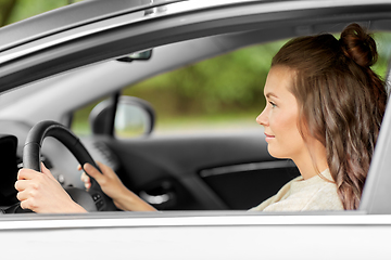 Image showing woman or female driver driving car in city