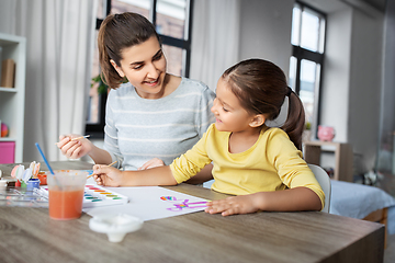 Image showing mother with little daughter drawing at home