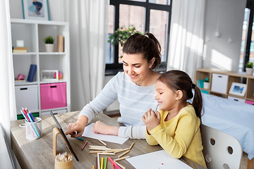 Image showing mother and daughter with tablet pc drawing at home