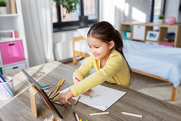 Image showing little girl drawing with coloring pencils at home