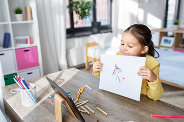 Image showing girl drawing and having video call on tablet pc