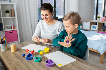 Image showing mother and son playing with modeling clay at home