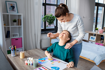 Image showing mother and son with colors drawing at home