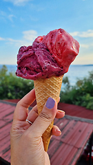 Image showing Gelato ice cream cone held up to the hot summer city