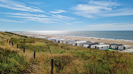 Image showing View from dunes on North Sea city beach on a sunny summer weekend. Typical pavilions. Zandvoort, Netherlands