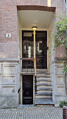 Image showing Typical houses and doors in Amsterdam Netherlands. Old European city summer landscape