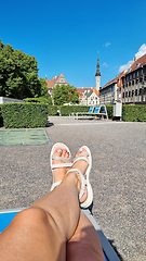 Image showing Slender tanned female legs in white shoes, selfie