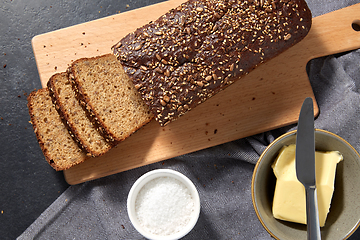 Image showing close up of bread, butter, knife and salt on towel