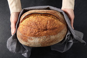 Image showing female baker with homemade bread at bakery