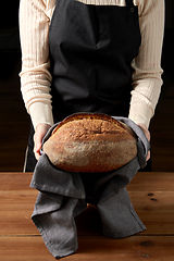 Image showing female baker with homemade bread at bakery