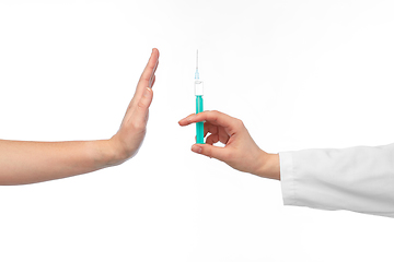 Image showing hand with syringe and showing stop gesture