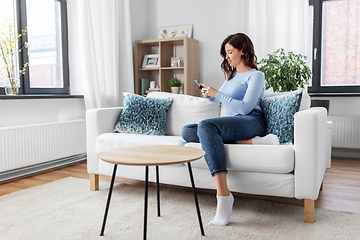 Image showing woman with smartphone at home