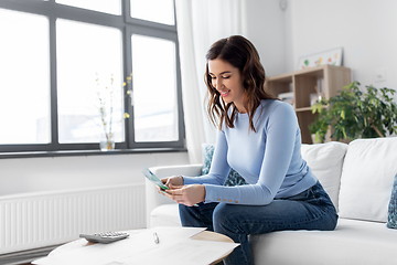 Image showing happy woman counting money at home