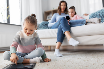 Image showing happy girl with tablet pc and family at home