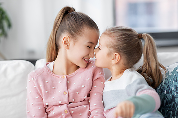 Image showing two happy smiling little girls or sisters at home