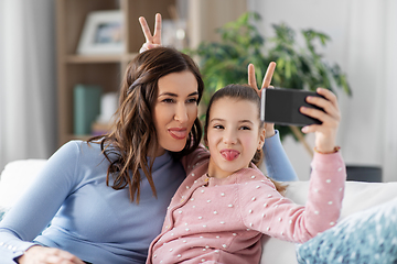 Image showing happy family taking selfie by smartphone at home