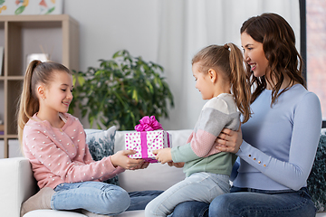 Image showing girl giving present to younger sister at home