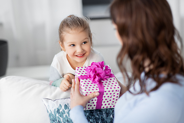 Image showing happy daughter giving present to mother at home