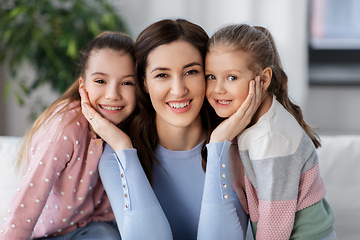 Image showing happy smiling mother with two daughters at home