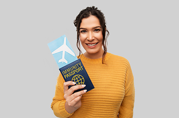 Image showing happy woman with air ticket and immunity passport