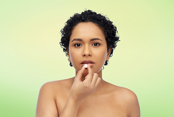 Image showing portrait of african american woman taking pill