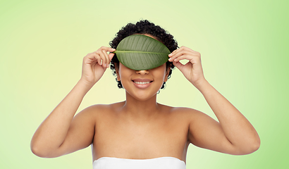 Image showing portrait of african american woman with green leaf