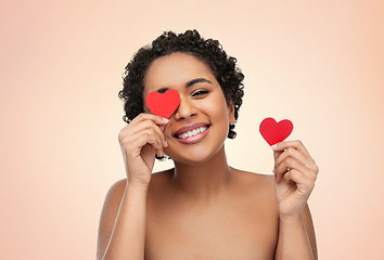 Image showing african american woman covering eyes with hearts