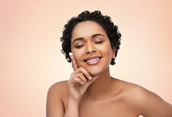 Image showing young african american woman with moisturizer