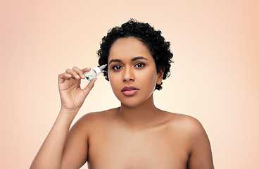 Image showing young african american woman with eye drops