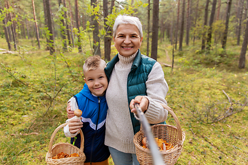 Image showing grandmother and grandson with baskets take selfie