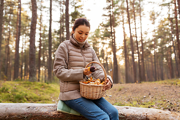 Image showing woman with mushrooms in basket in autumn forest