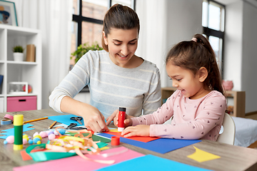 Image showing daughter with mother making applique at home