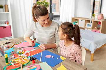 Image showing daughter with mother making applique at home