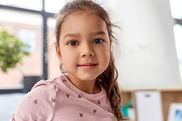 Image showing happy smiling little girl sitting on bed at home