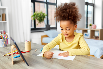 Image showing little girl drawing with coloring pencils at home