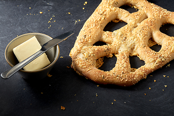 Image showing close up of cheese bread, butter and table knife