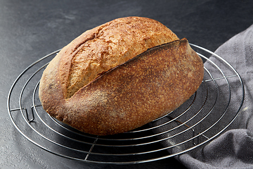 Image showing homemade craft bread on stand on table