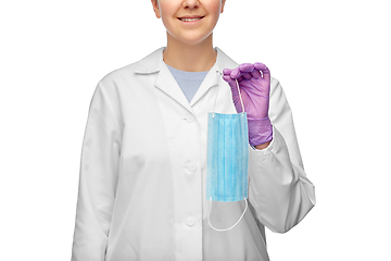 Image showing smiling female doctor holding medical mask