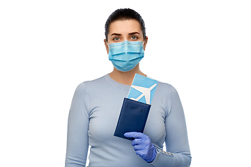 Image showing young woman in mask with air ticket and passport