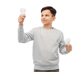 Image showing smiling boy comparing different light bulbs