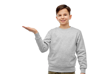 Image showing happy boy holding something imaginary on hand