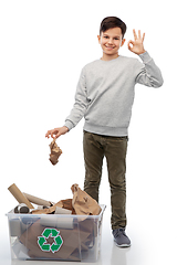 Image showing smiling boy sorting paper waste showing ok sign