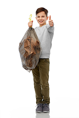 Image showing smiling boy with paper garbage in plastic bag