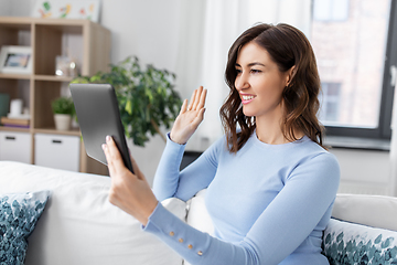 Image showing woman having video call on tablet pc at home